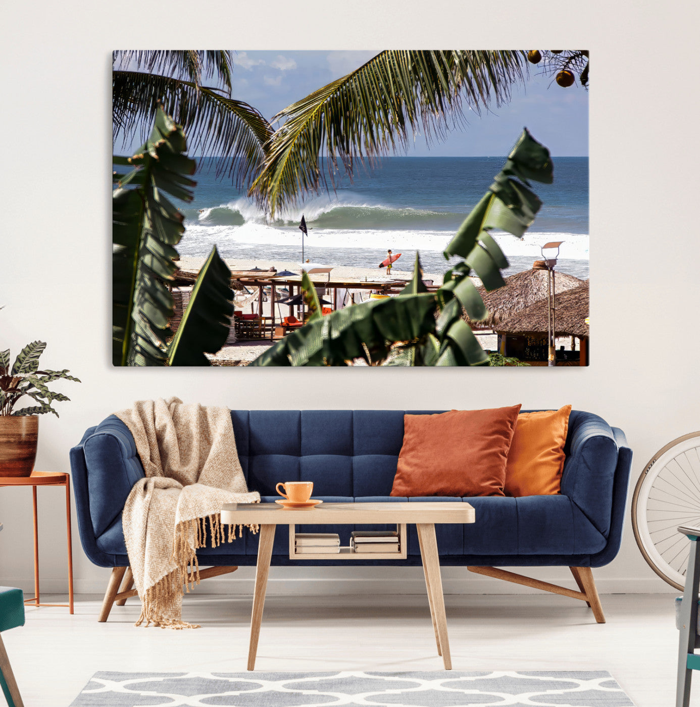 Canvas wall art of a tropical surf scene framed by palm trees, with a surfer on the shore and waves rolling in, ideal for beach-themed decor.