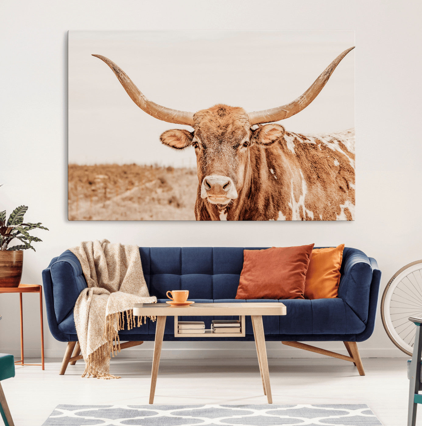 Sepia-toned Texas Longhorn facing forward in a dry field, perfect for rustic farmhouse or western-themed neutral home decor.