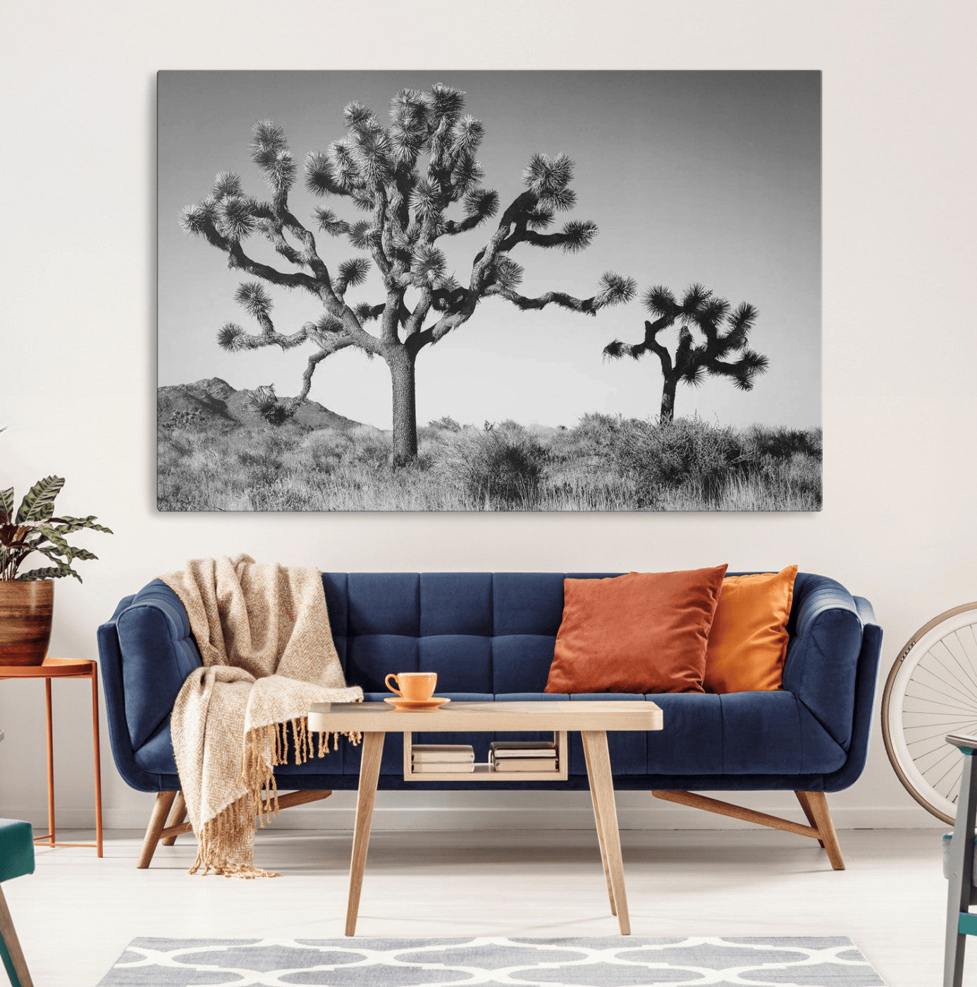 Black and white desert scene with two Joshua trees under clear sky, perfect for rustic or boho-inspired home decor.