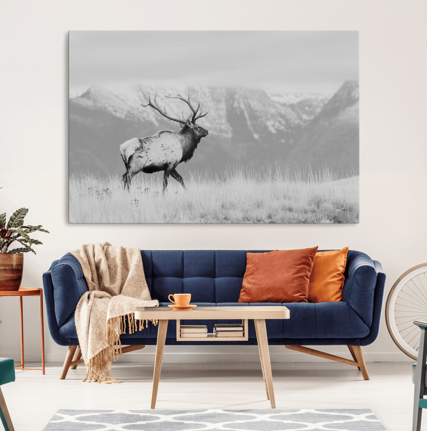 Black and white elk standing in front of snowy mountain range, perfect for rustic lodge or nature-inspired wall decor.