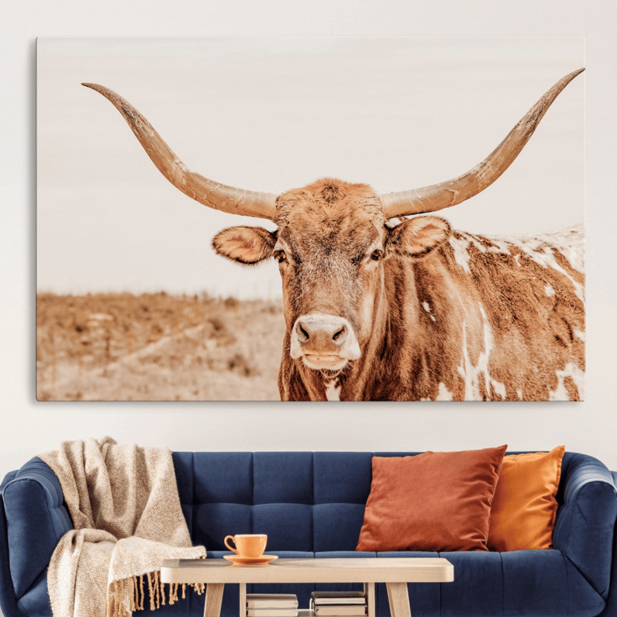 A longhorn bull standing proudly in a sunlit desert field with warm neutral tones, ideal for rustic western or farmhouse interiors.