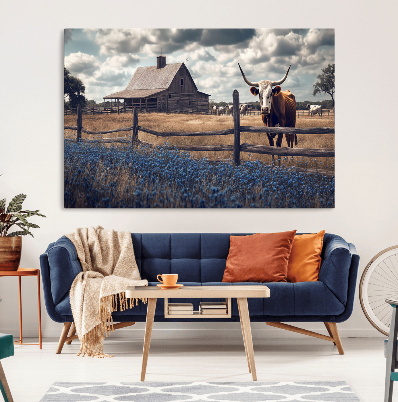 Framed canvas art of a Texas Longhorn cow near a rustic barn and bluebonnet field, ideal for country-style or farmhouse wall decor.