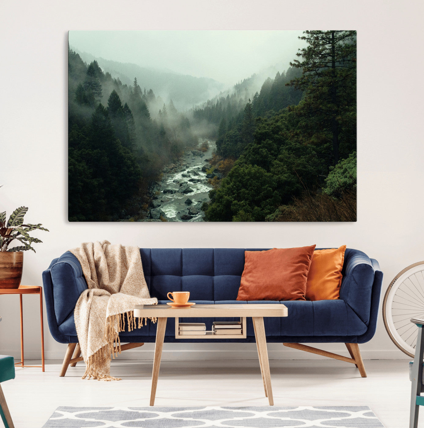 Misty forest with a winding river flowing through lush green mountains, creating a tranquil and moody wilderness landscape.