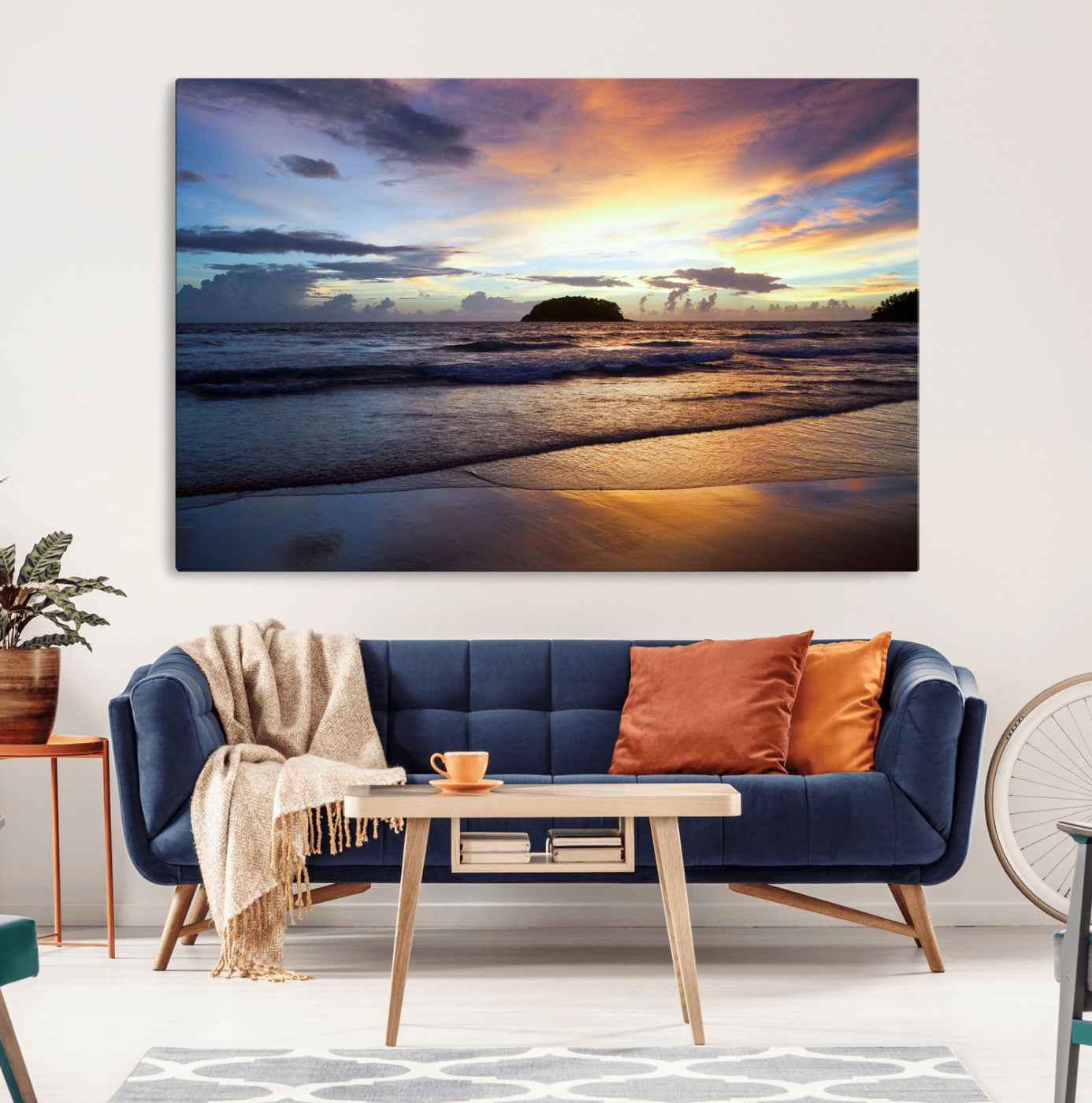 A tropical beach at sunset with waves gently washing ashore, reflecting golden and purple hues in the sky, creating a tranquil coastal scene.