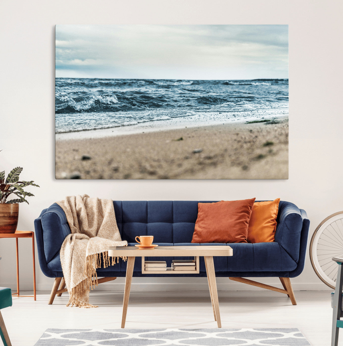 A moody ocean scene with gentle waves washing onto a sandy beach under a cloudy sky, creating a peaceful and coastal atmosphere.