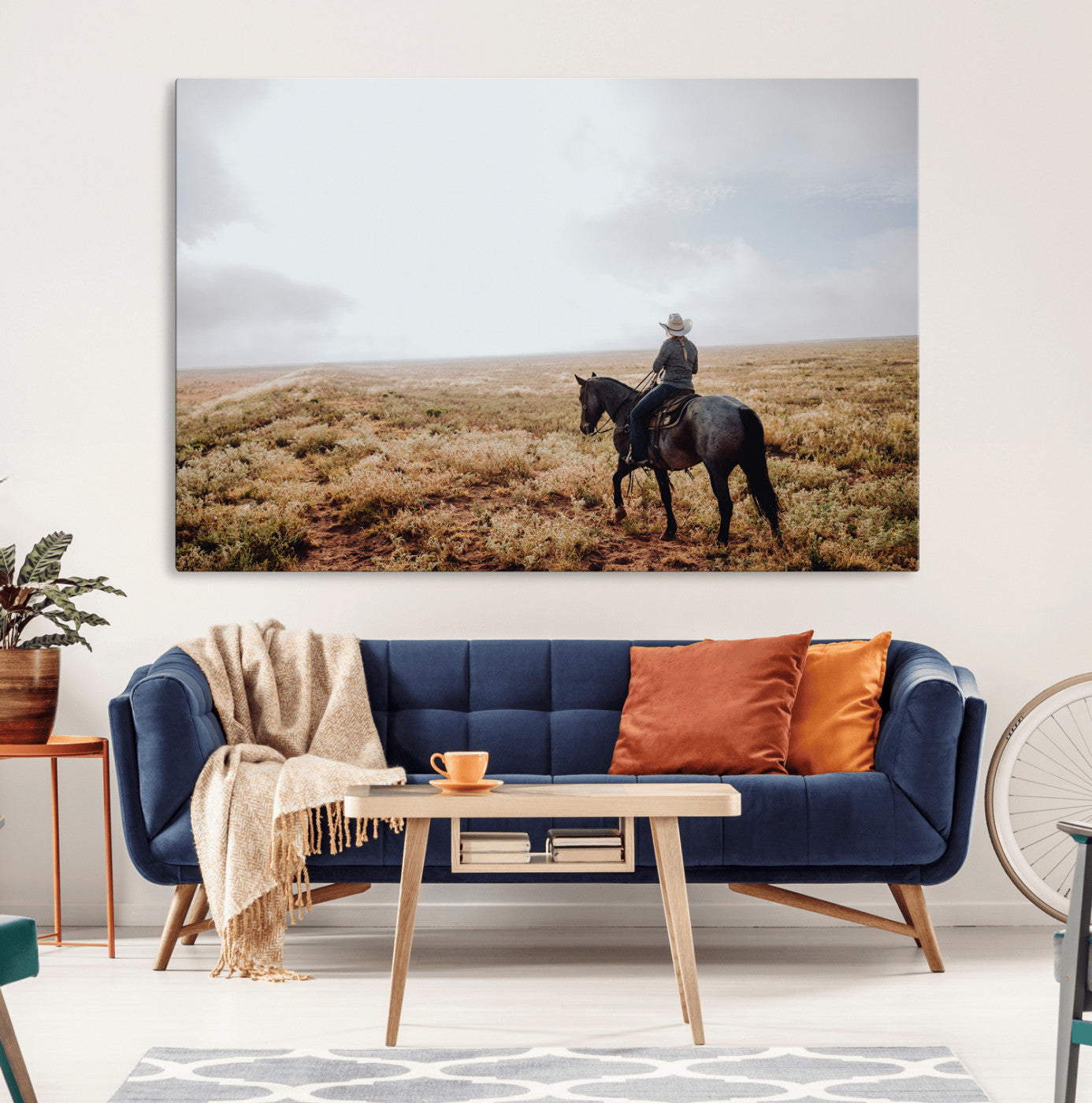 A lone cowboy riding horseback across an open prairie under a vast sky, capturing the rugged and timeless spirit of the Western frontier.
