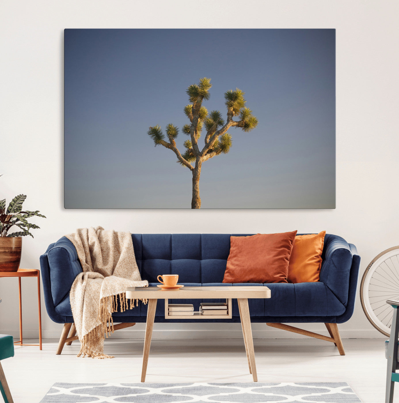A lone Joshua Tree standing against a deep blue sky, capturing the serene and rugged beauty of the Southwestern desert landscape.