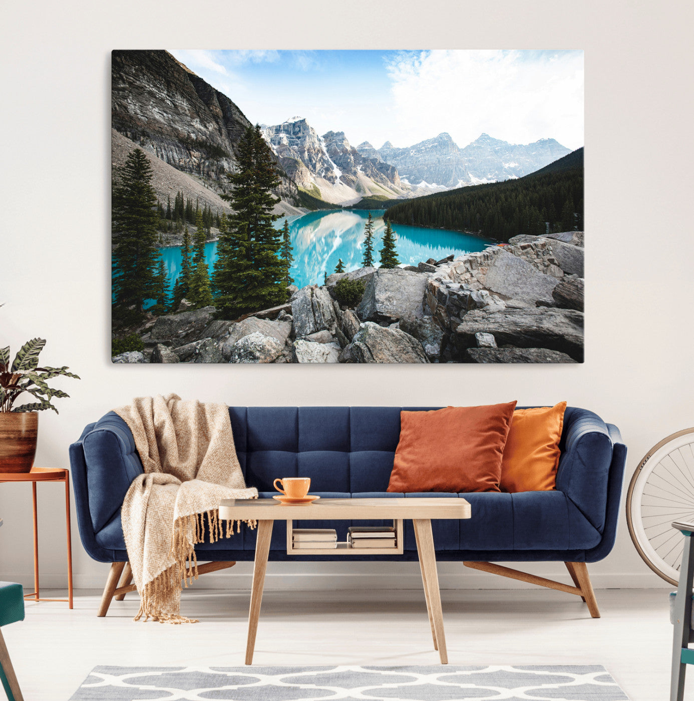 Stunning view of Moraine Lake with turquoise waters reflecting snow-capped mountains and evergreen trees, creating a peaceful alpine decor.