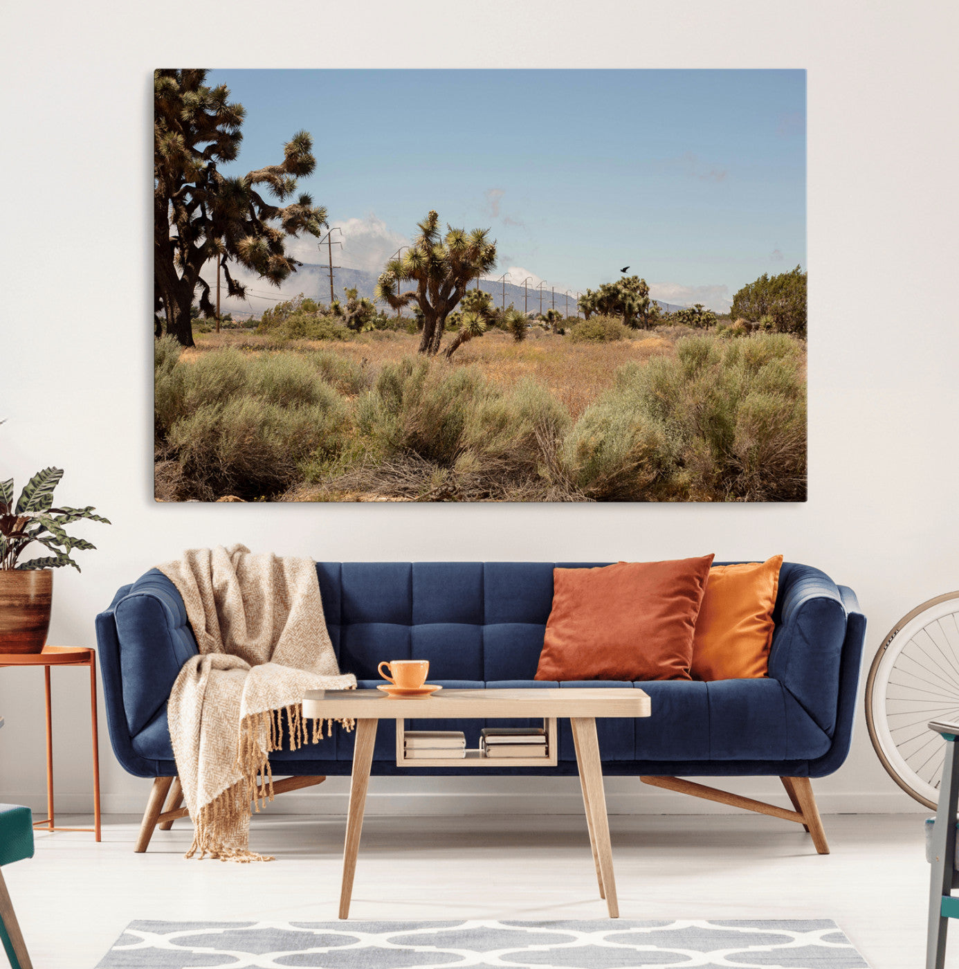 Scenic desert landscape with Joshua trees, dry grass, and distant mountains under a clear blue sky, perfect for southwestern and rustic decor.