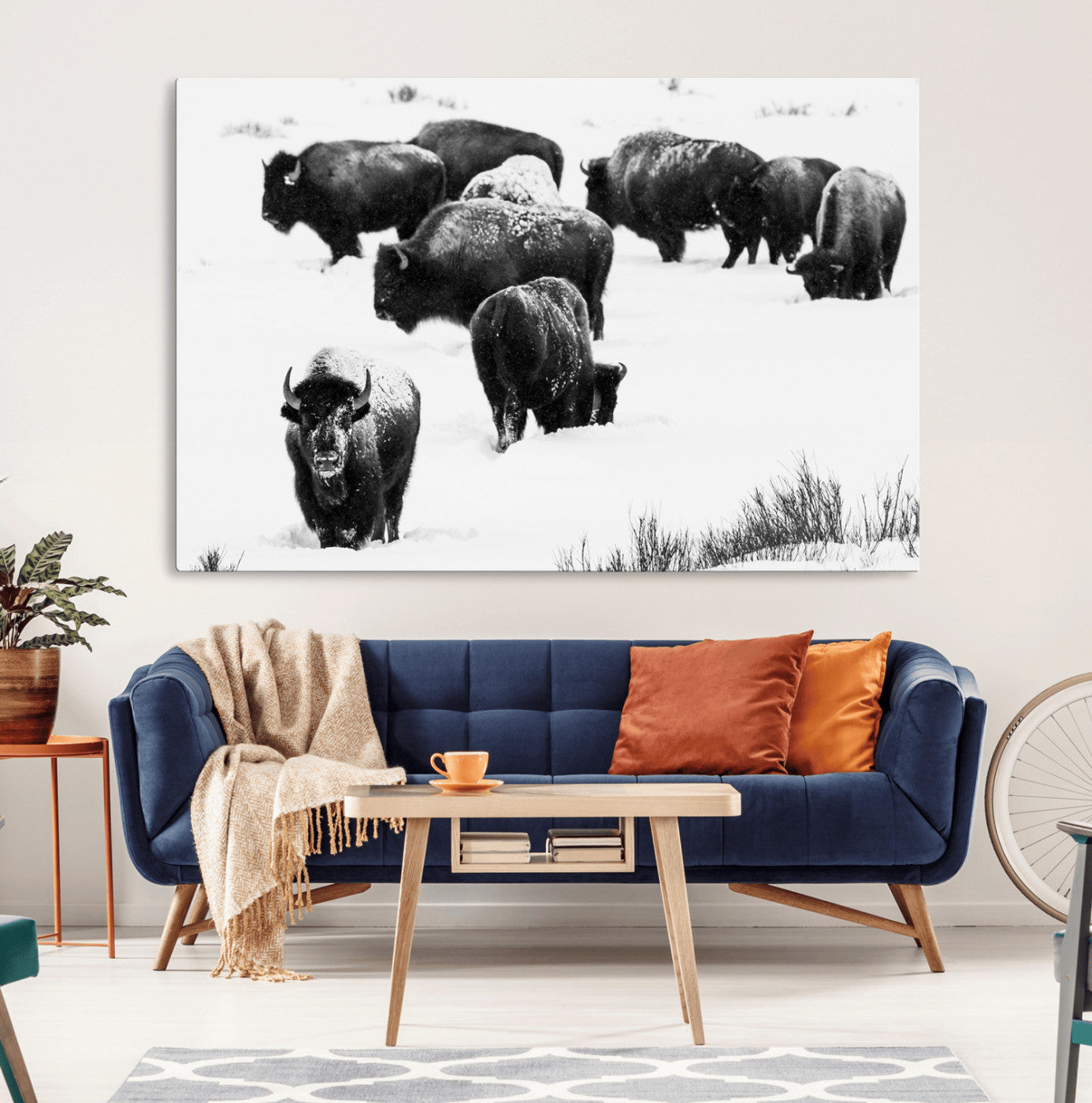 Black and white photograph of a bison herd in a snowy landscape, with snow-covered fur and a rugged wilderness setting, perfect for rustic lodge decor.
