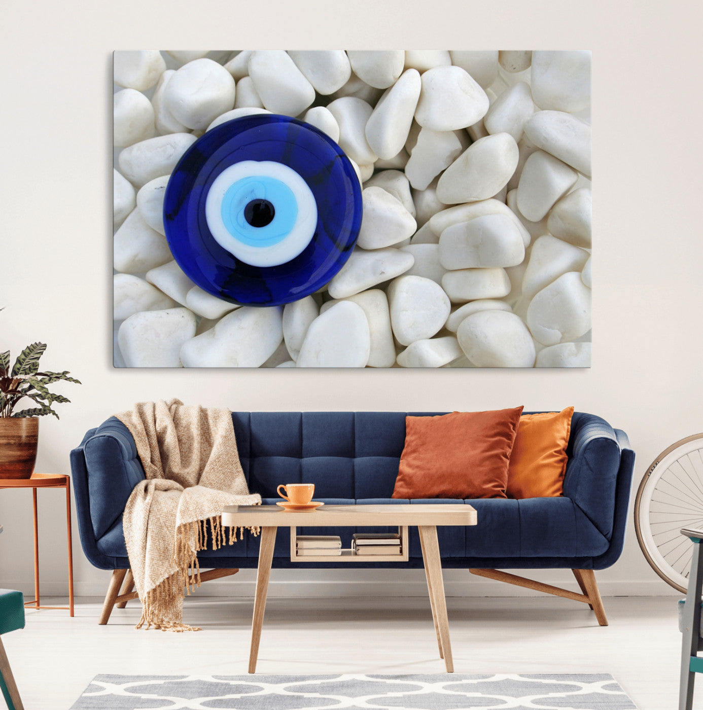 A close-up of a blue evil eye charm placed on white pebbles, symbolizing protection and good luck.