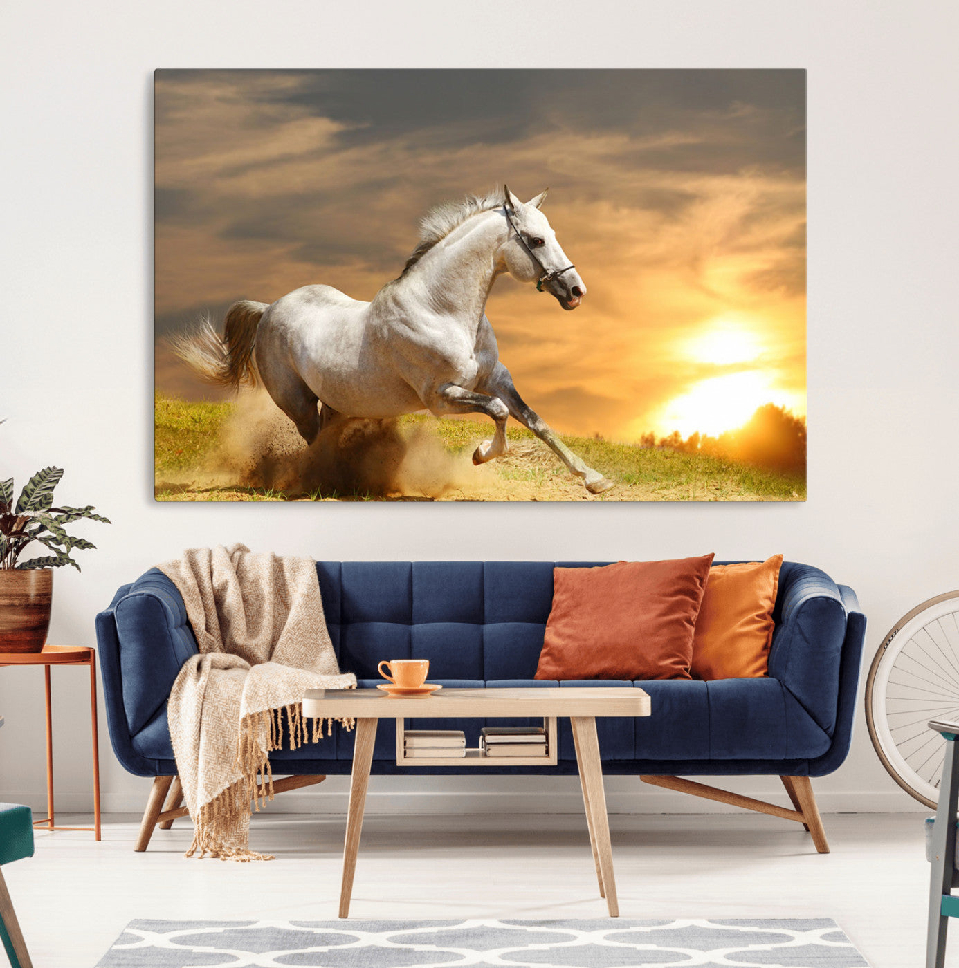 A powerful white horse galloping through the field at sunset, with the golden light illuminating its mane and the vibrant sky in the background.