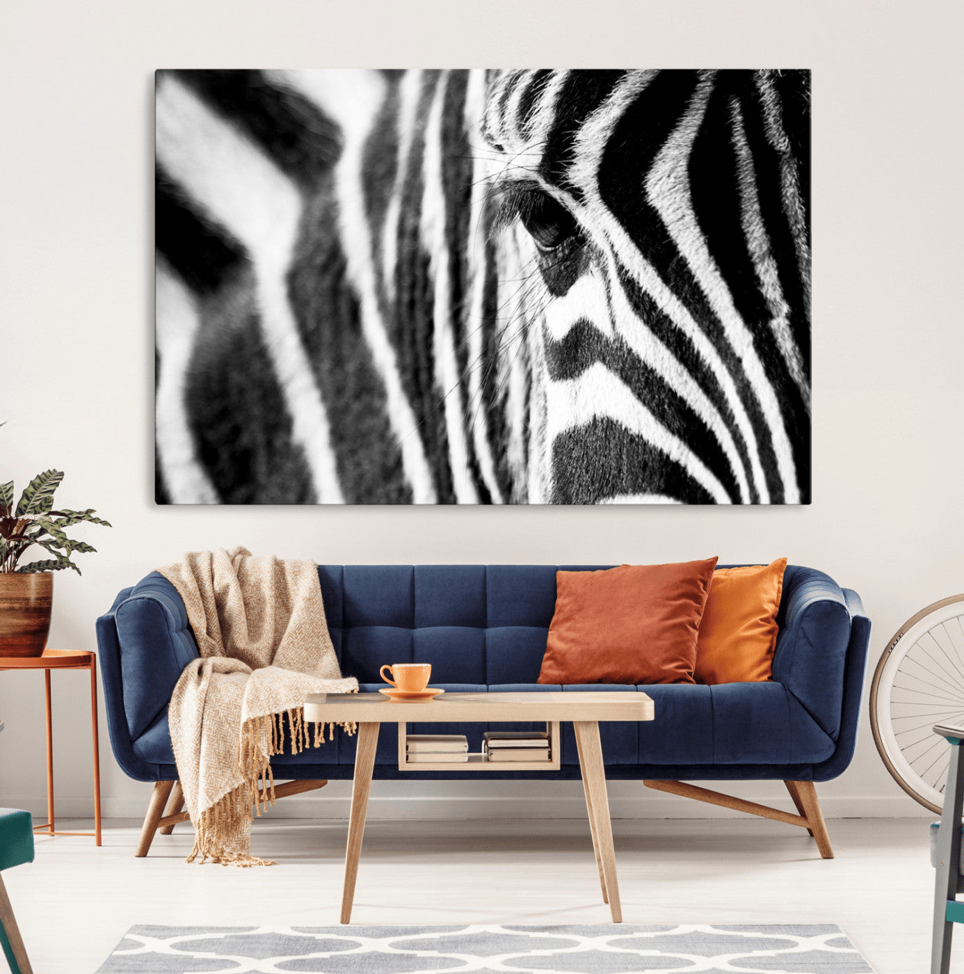 A close-up black and white photograph of a zebra's eye, showcasing the intricate patterns of its stripes in sharp detail.