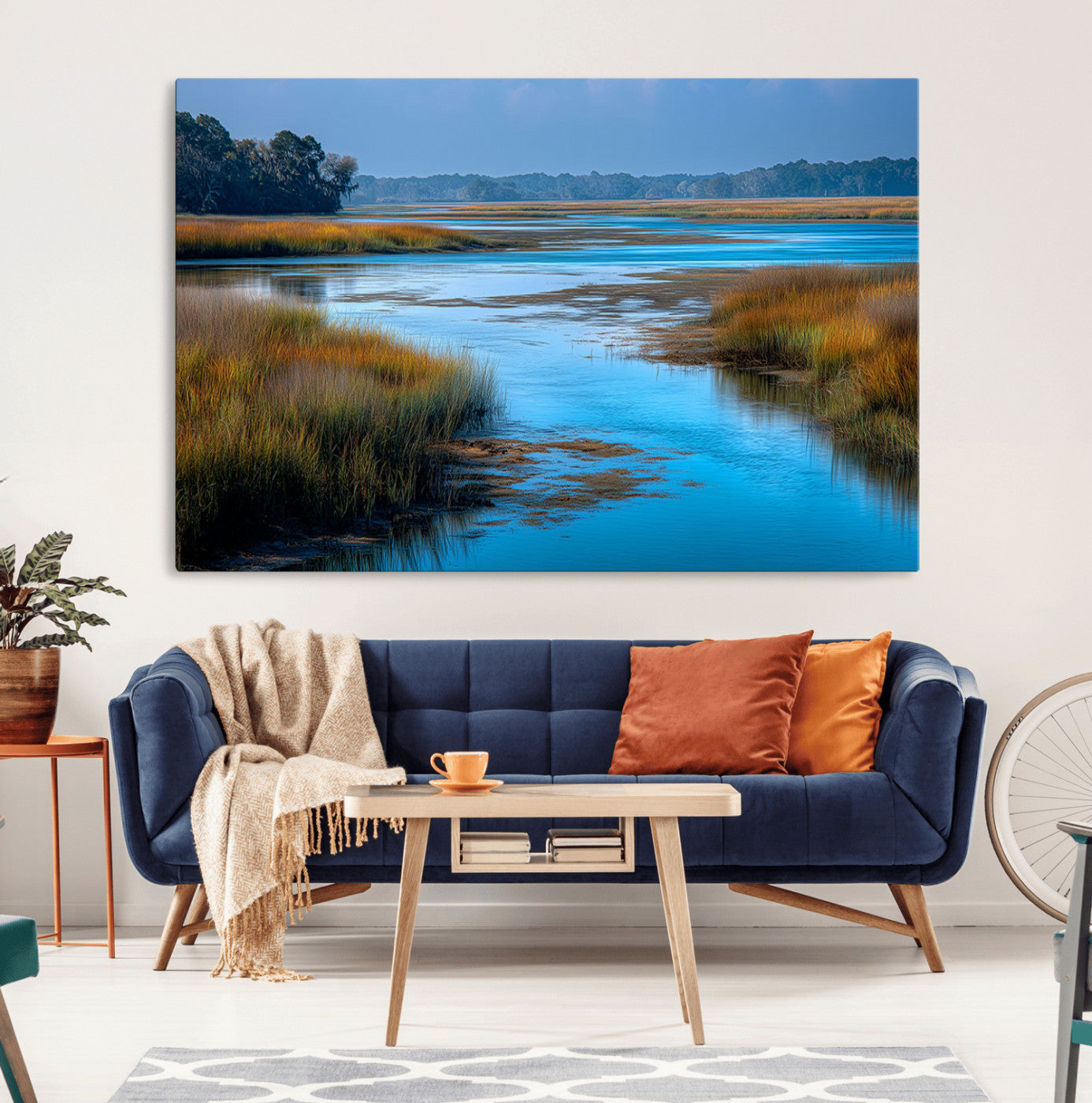 A peaceful marshland scene with calm blue water reflecting the surrounding grasses and trees, capturing the beauty of nature in a serene landscape.