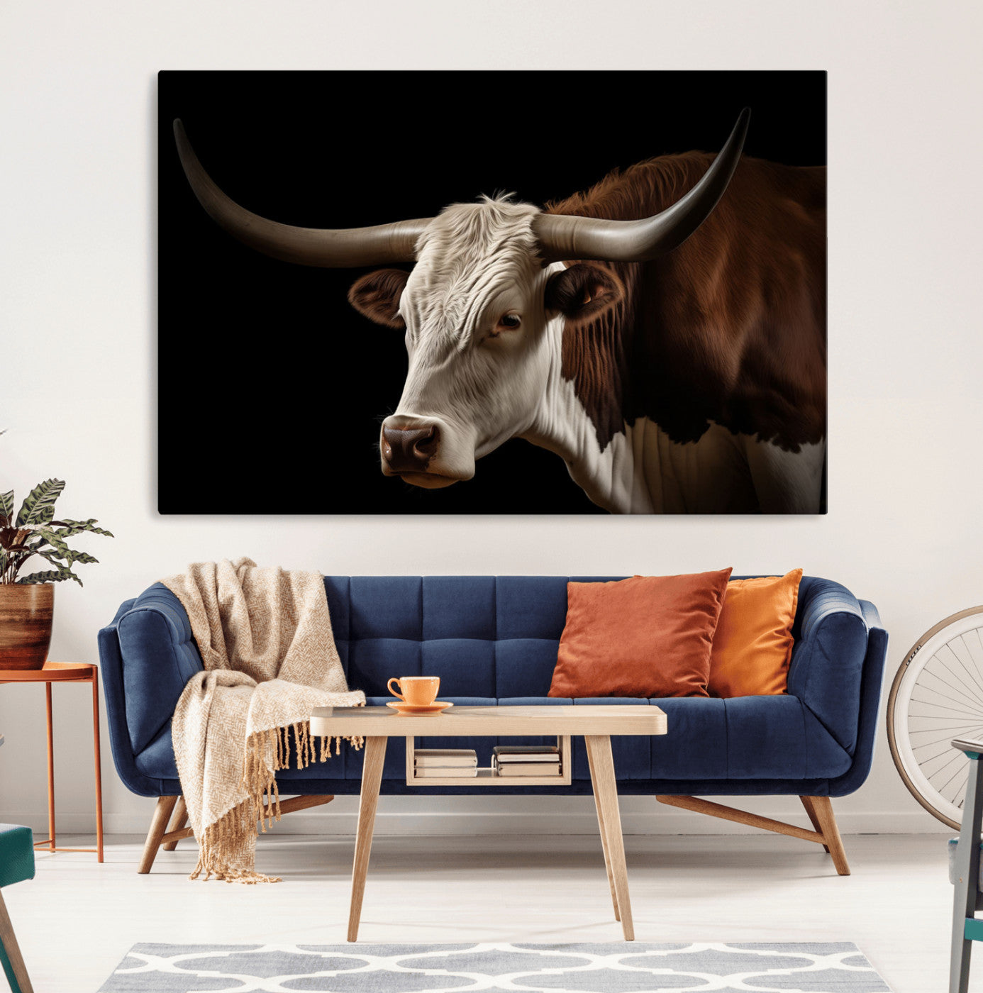 "Close-up of a brown and white longhorn cow with prominent curved horns against a black background."