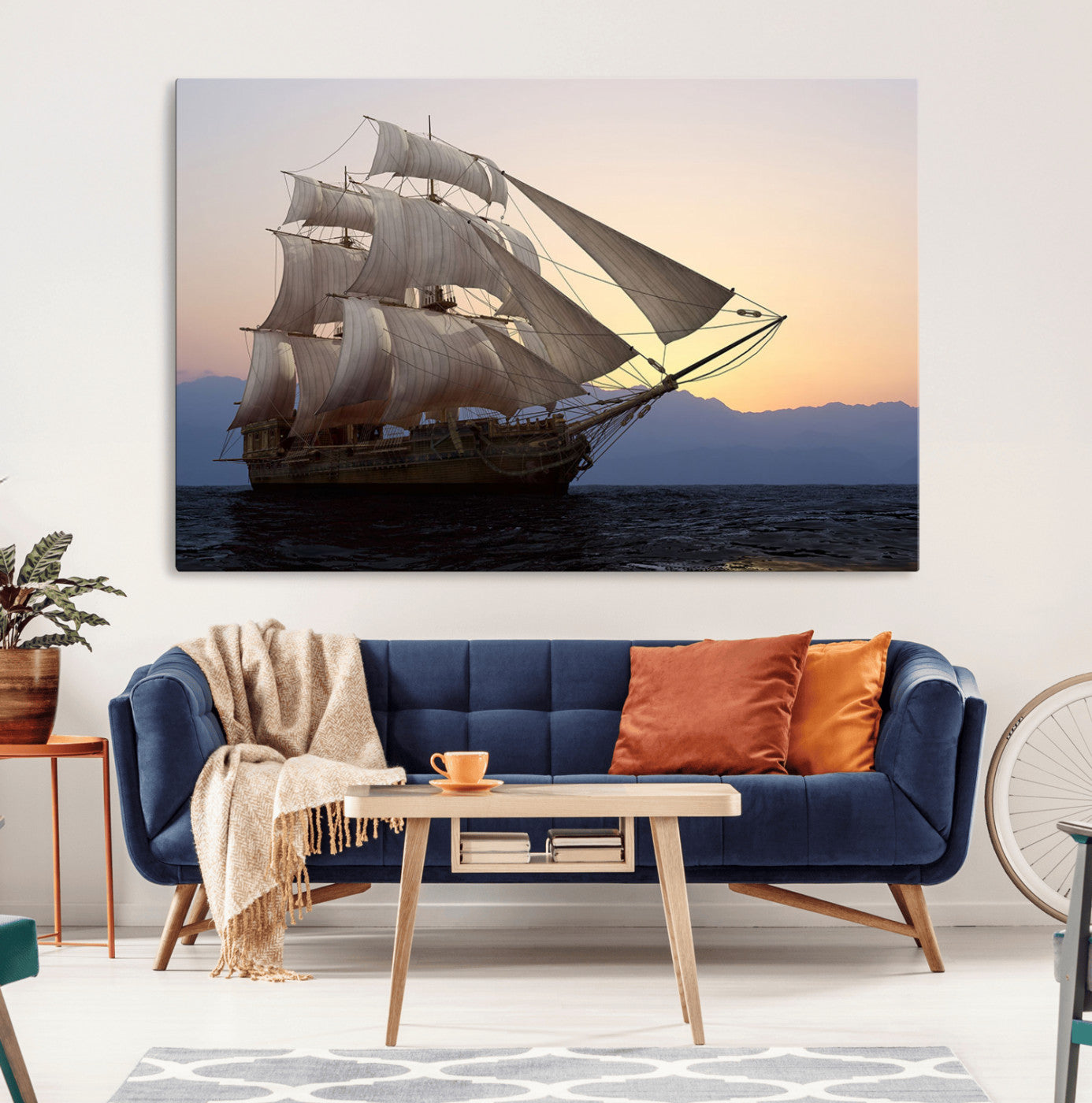Majestic tall ship with full sails gliding across the ocean at sunset, with mountain silhouettes in the background – Wall Art Canvas Print.