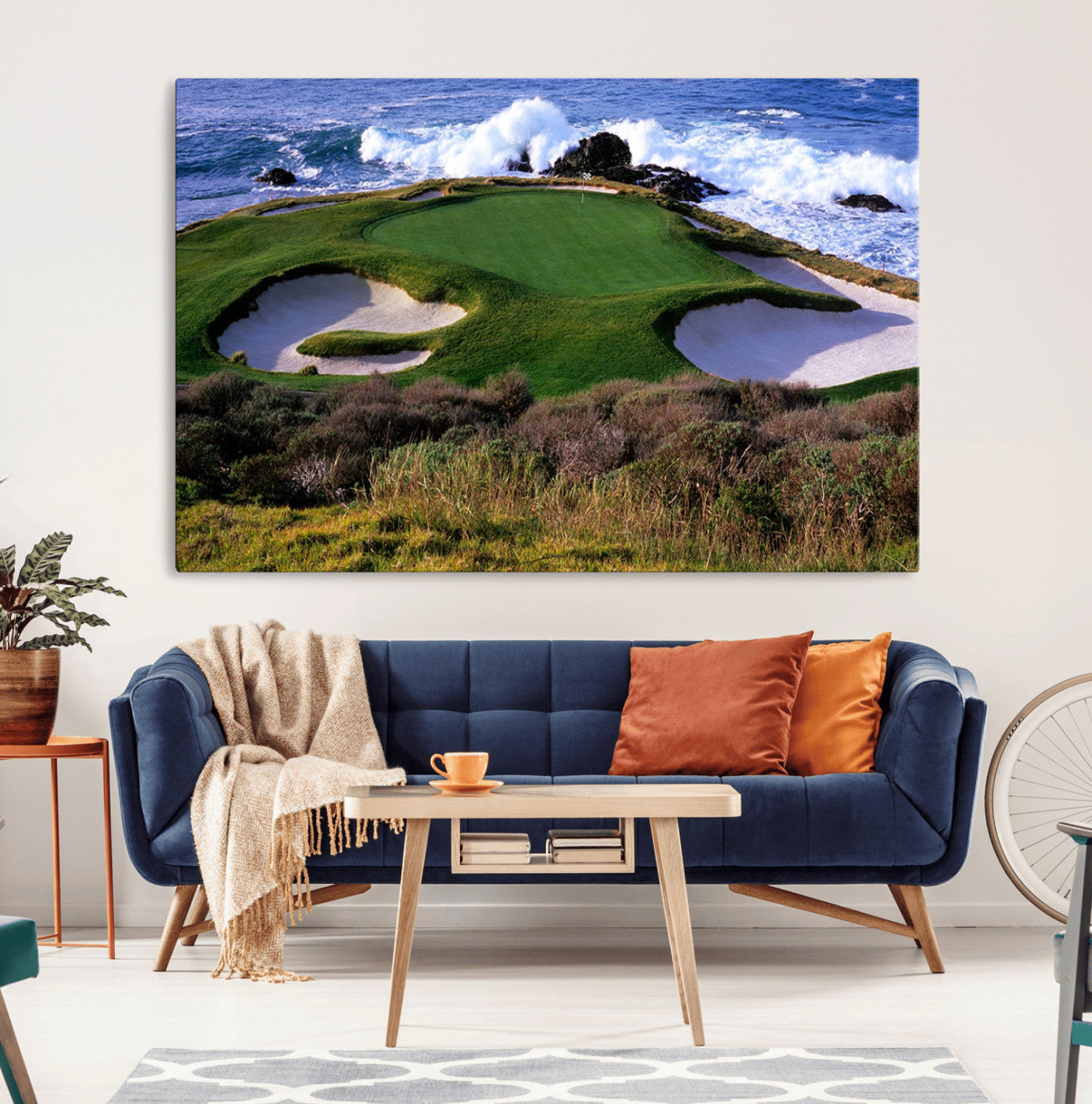 A scenic golf course located by the ocean, featuring a well-manicured green surrounded by sand traps and powerful ocean waves crashing on the shore.