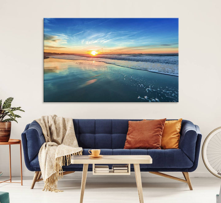 The Blue Sky and Beach Wall Art Canvas Print features a vibrant orange sky reflecting on wet sand.