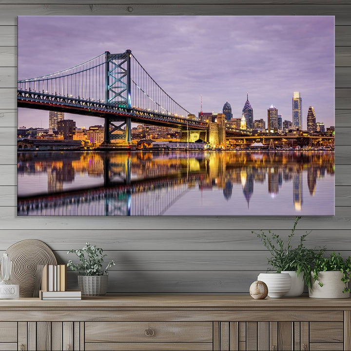 A woman holds the Philadelphia Ben Franklin Bridge Wall Art Canvas Print, a gallery-quality photo showcasing a city skyline with the bridge reflecting on the river. This stunning piece would make an excellent addition as premium canvas wall art for any home.