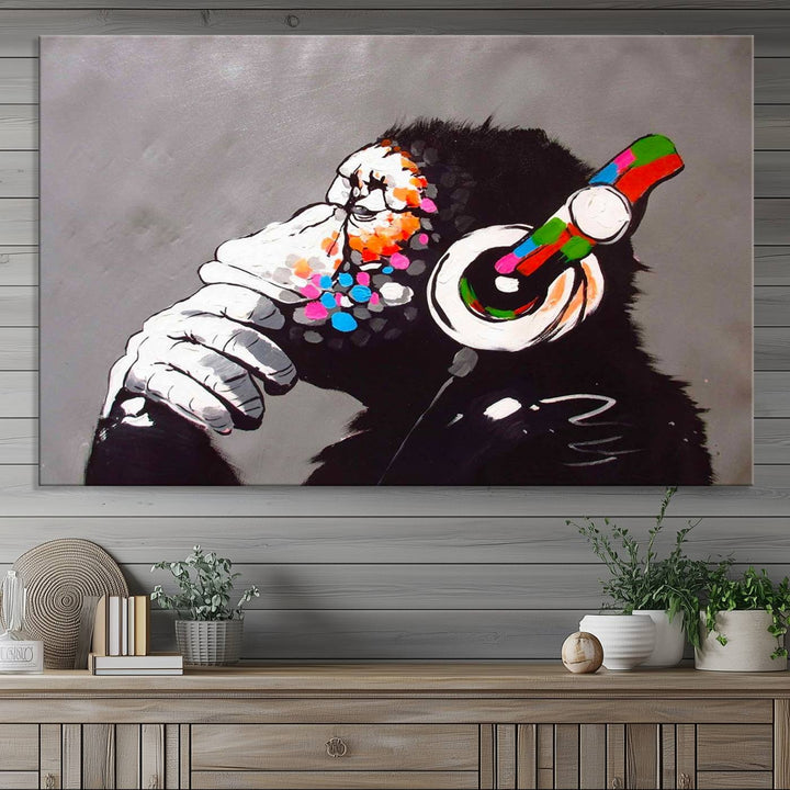 A vibrant triptych, the "DJ Monkey Listening to Music" wall art print, features a Banksy-inspired large canvas adorned with colorful modern pop art. This striking piece elegantly enhances the room with its dynamic and lively depiction.