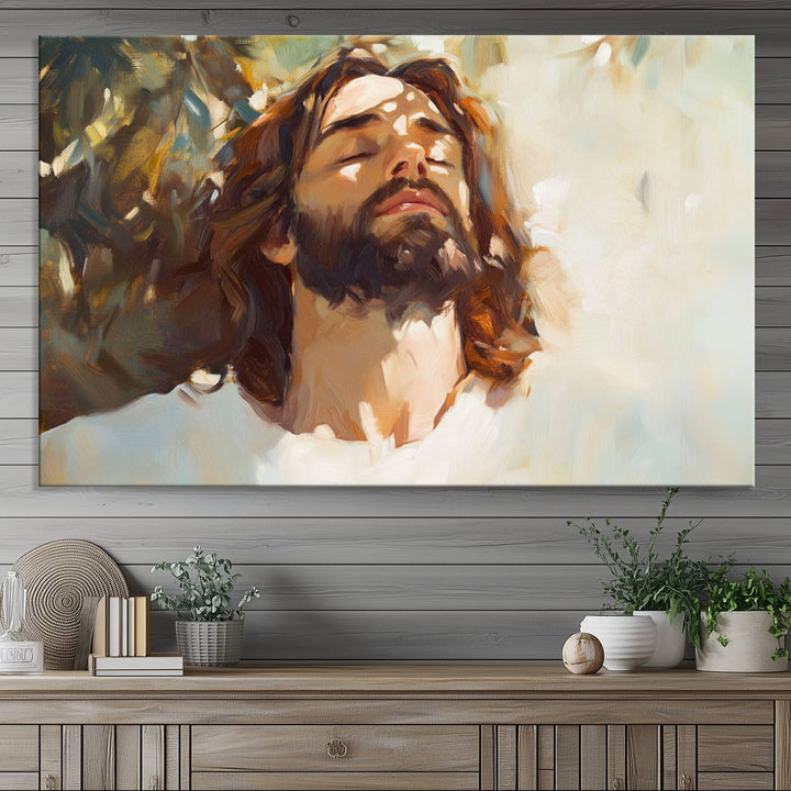 The Jesus Portrait Wall Art Canvas Print features a depiction of Jesus Christ with closed eyes, basking in sunlight. His expression exudes a peaceful, spiritual atmosphere against a blurred background.