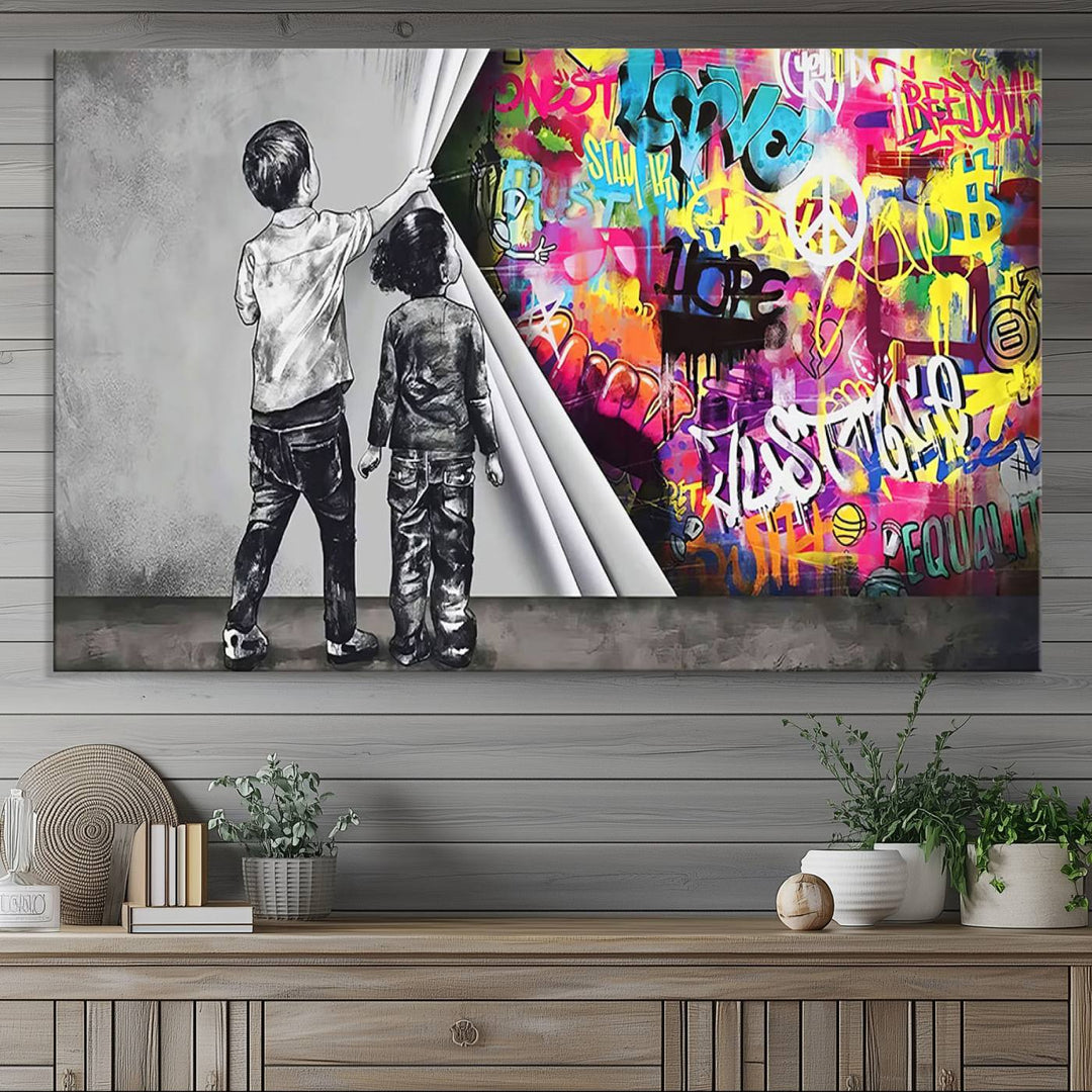 The Banksy Print - Street Art Canvas features a vibrant and bold image of two children lifting a curtain to reveal colorful graffiti. It's ready to hang, adding an urban modern decor vibe.