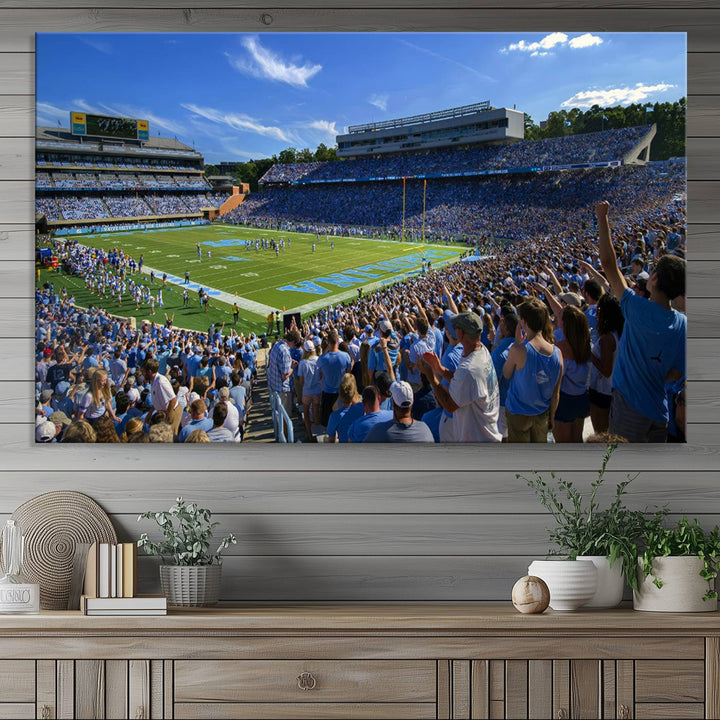 A gallery-quality canvas wall art print featuring the University of North Carolina Tar Heels Football Team and Chapel Hill's Kenan Memorial Stadium adorns the cafe wall.