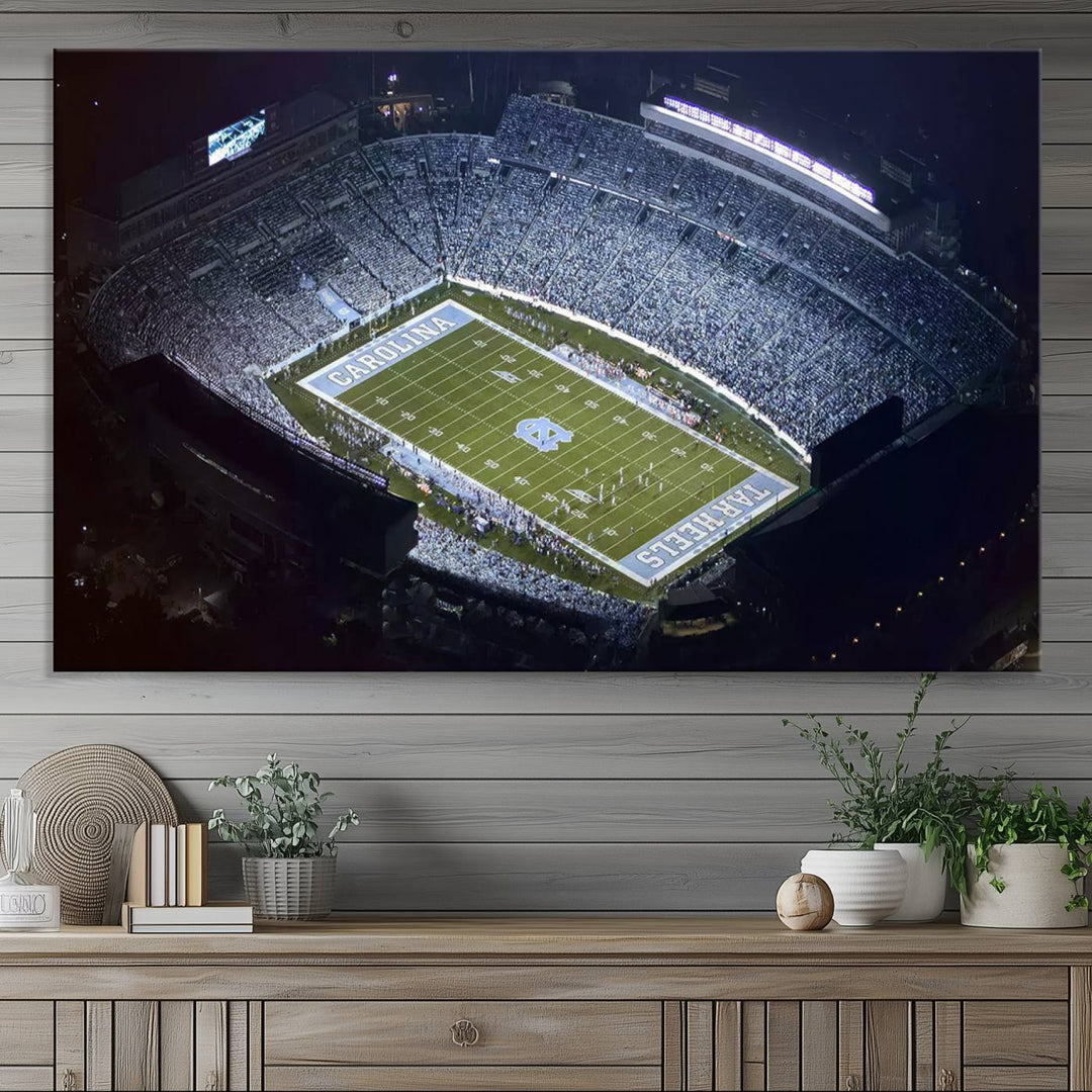 A University of North Carolina Tar Heels Football Team Print, showcasing Chapel Hill's Kenan Memorial Stadium, hangs in a modern dining room, adding a gallery-quality finish that enhances the entire space.