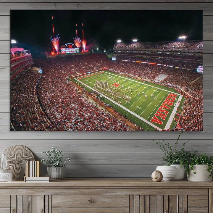 The University of Nebraska Cornhuskers Football Team Print, featuring Lincoln Memorial Stadium in a vibrant triptych canvas with fireworks above and a gallery-quality finish, is elegantly displayed.