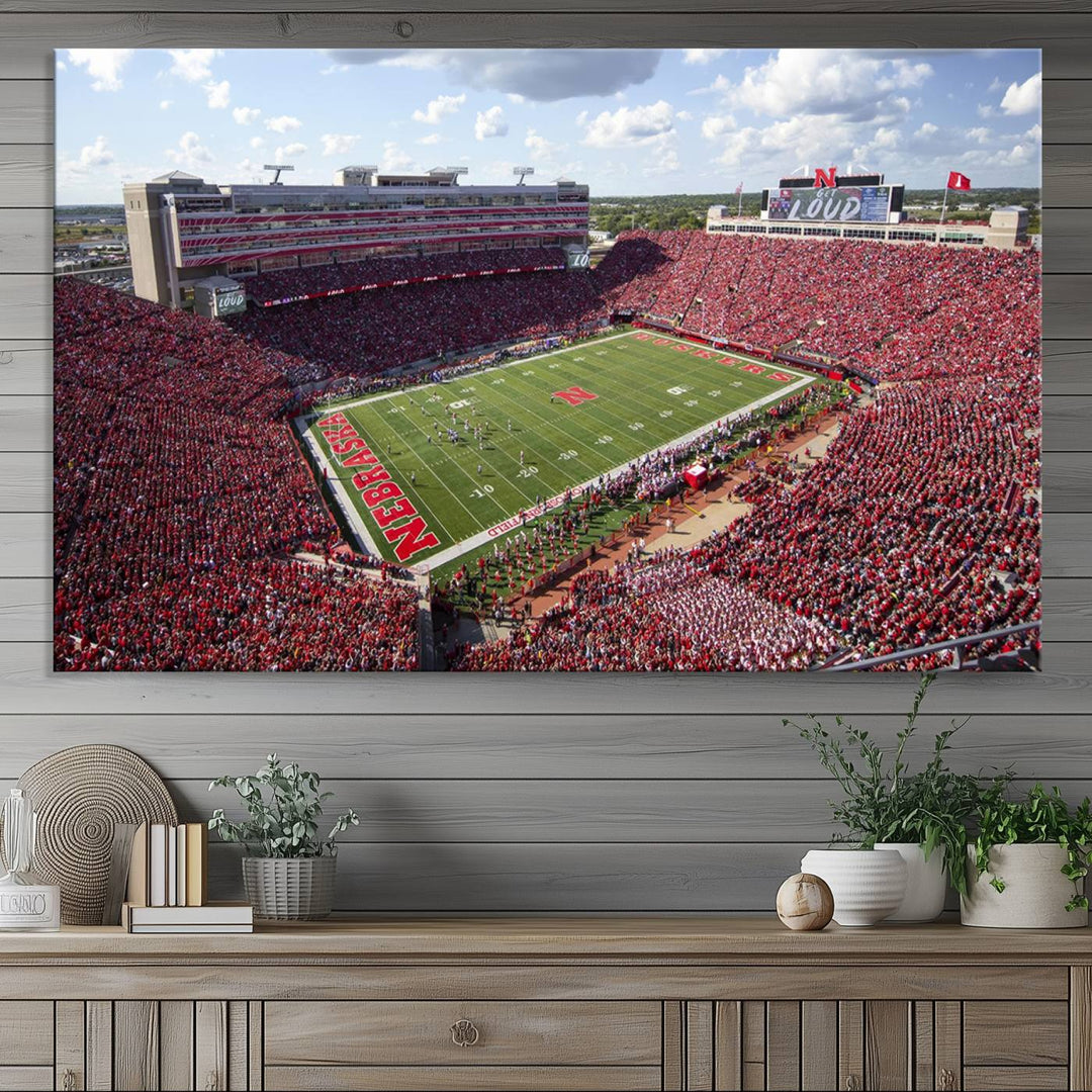 The University of Nebraska Cornhuskers Football Team Print showcases a vibrant triptych of Lincoln Memorial Stadium, depicting a packed football stadium filled with energetic fans. This handmade art piece is crafted in the USA and printed on premium canvas for a gallery-quality finish.