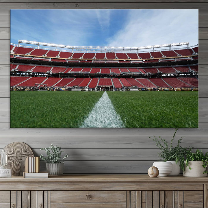 A canvas print of the University of Tulsa Golden Hurricane showcases H.A. Chapman Stadiums football field and red seats against a backdrop of a blue sky.