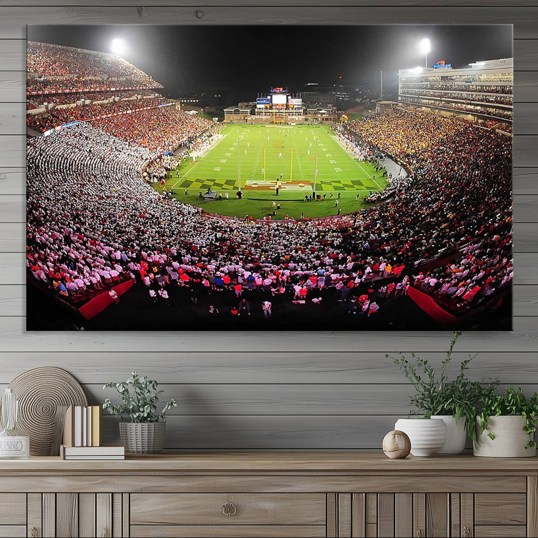 The Maryland Terrapins Football Wall Art Canvas showcases a packed SECU Stadium at night with a bright field and cheering fans.