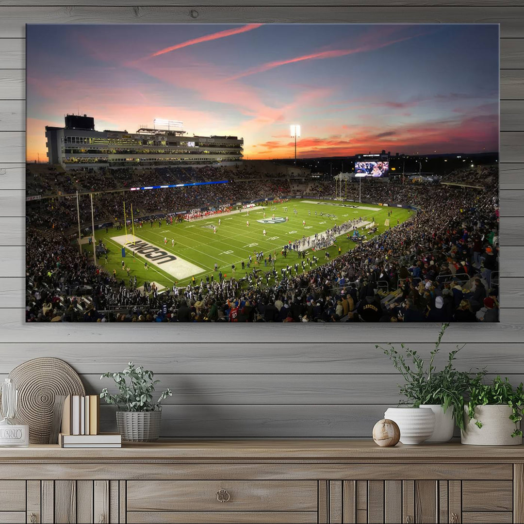 This wall art canvas print captures UCONN Huskies fans energizing a sunset scene at East Hartfords Pratt & Whitney Stadium.