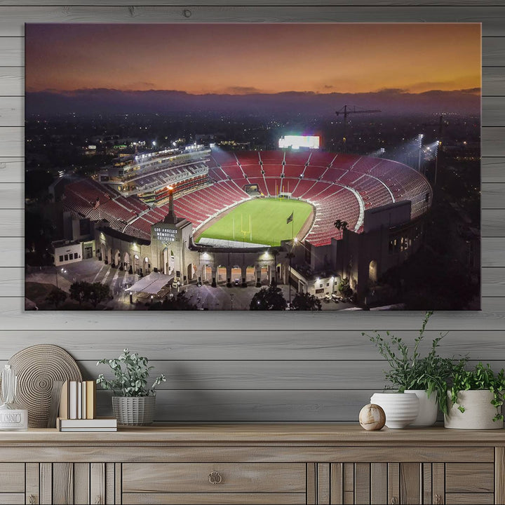 The USC Trojans Stadium canvas captures Memorial Coliseum at twilight, showcasing red seats and a green field beneath an orange sky.