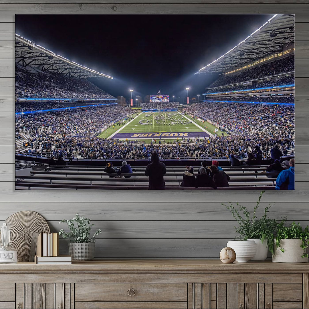 A canvas print titled The University of Washington Huskies Football depicts a packed Husky Stadium at night, as seen from the stands.