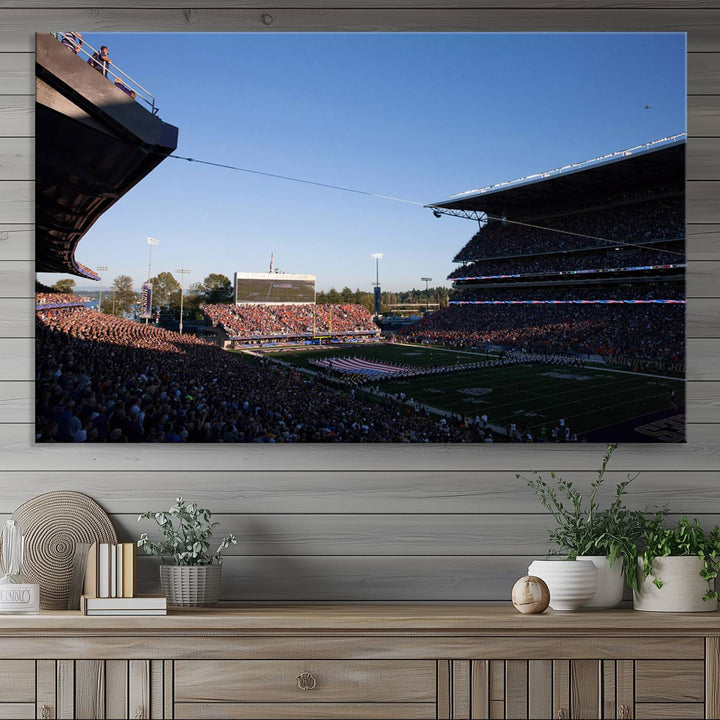 The University of Washington Huskies wall art print depicts Husky Stadium coming alive with fans as flags flutter.