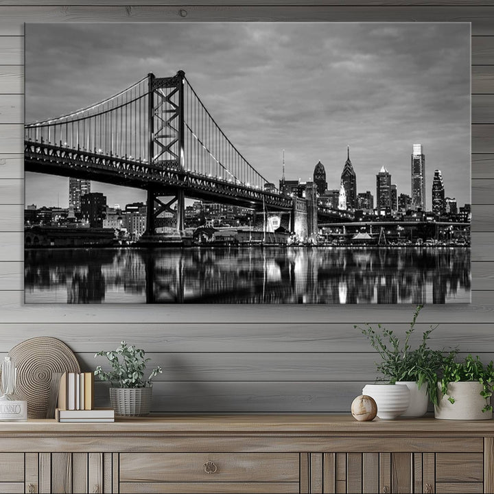 The "Large Wall Art Philadelphia Canvas Print" showcases a black-and-white depiction of the Ben Franklin Bridge with a water reflection.