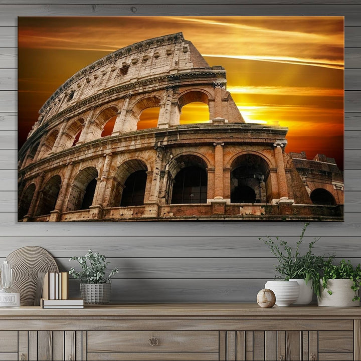 On the wall, theres a piece of art titled Colosseum with Yellow Sunset Behind, Italy.