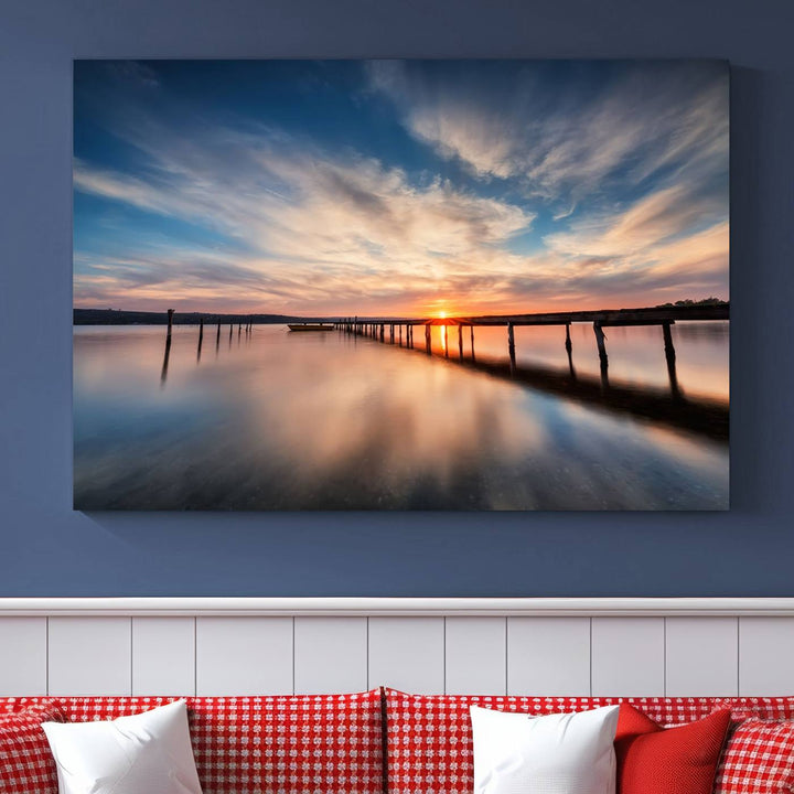 The Sunset Pier Canvas features a serene coastal landscape with vibrant hues under cloudy skies, ideal for modern decor.