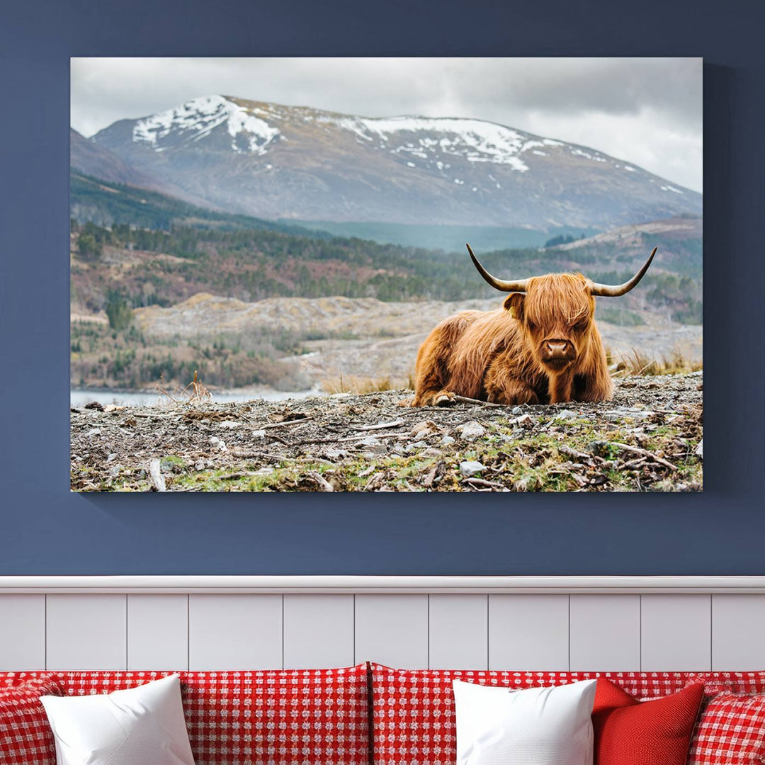 Highland Cow Horn Farm Wall Art Canvas Print is displayed against a wooden wall featuring a mountainous backdrop.