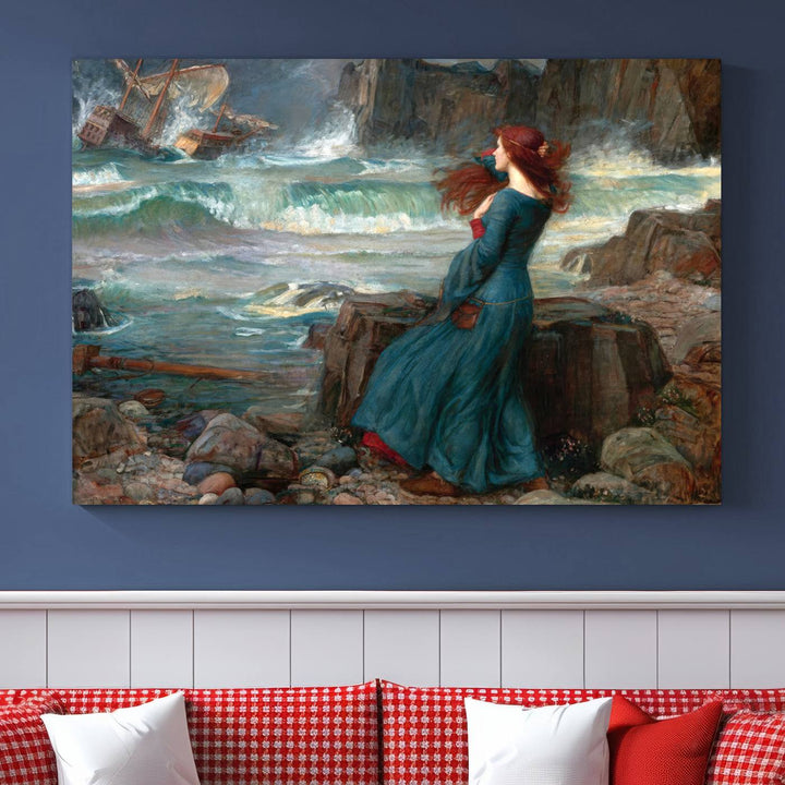 The Miranda by the Shore Wall Art Canvas Print depicts a woman in a blue dress standing by the sea, watching a shipwreck.