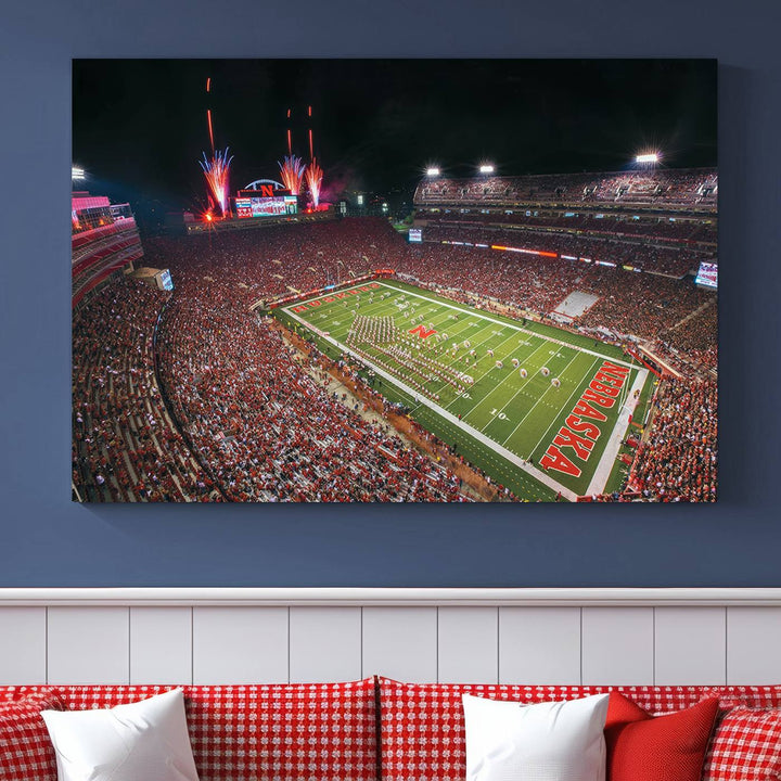 The University of Nebraska Cornhuskers Football Team Print, featuring Lincoln Memorial Stadium in a vibrant triptych canvas with fireworks above and a gallery-quality finish, is elegantly displayed.