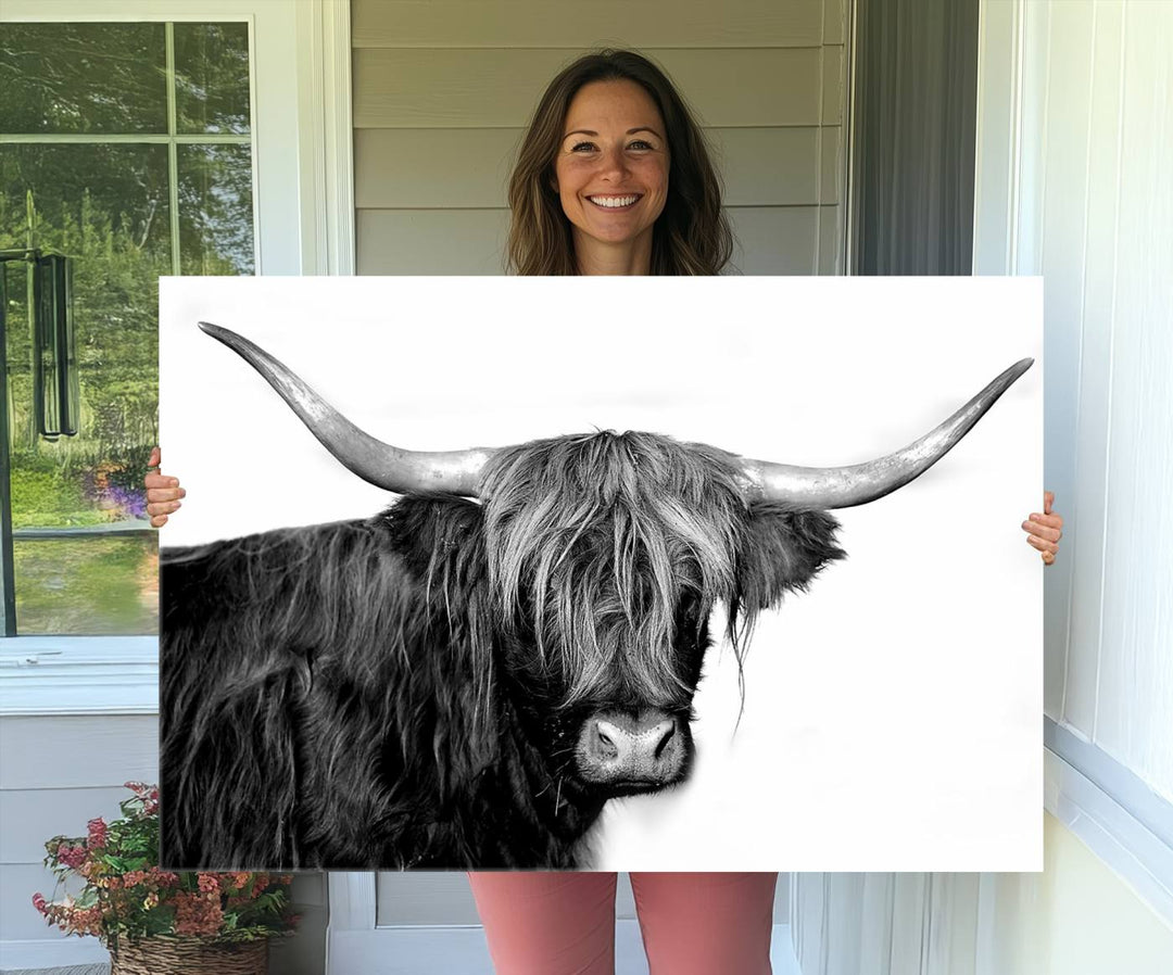 The Black and White Highland Cow Multi Panel Wall Art Canvas Print with UV-protection hangs prominently.