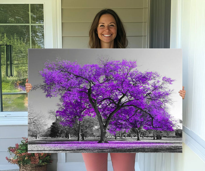 The Big Purple Tree Wall Art Canvas Print showcases a vibrant purple tree set against a black-and-white landscape.