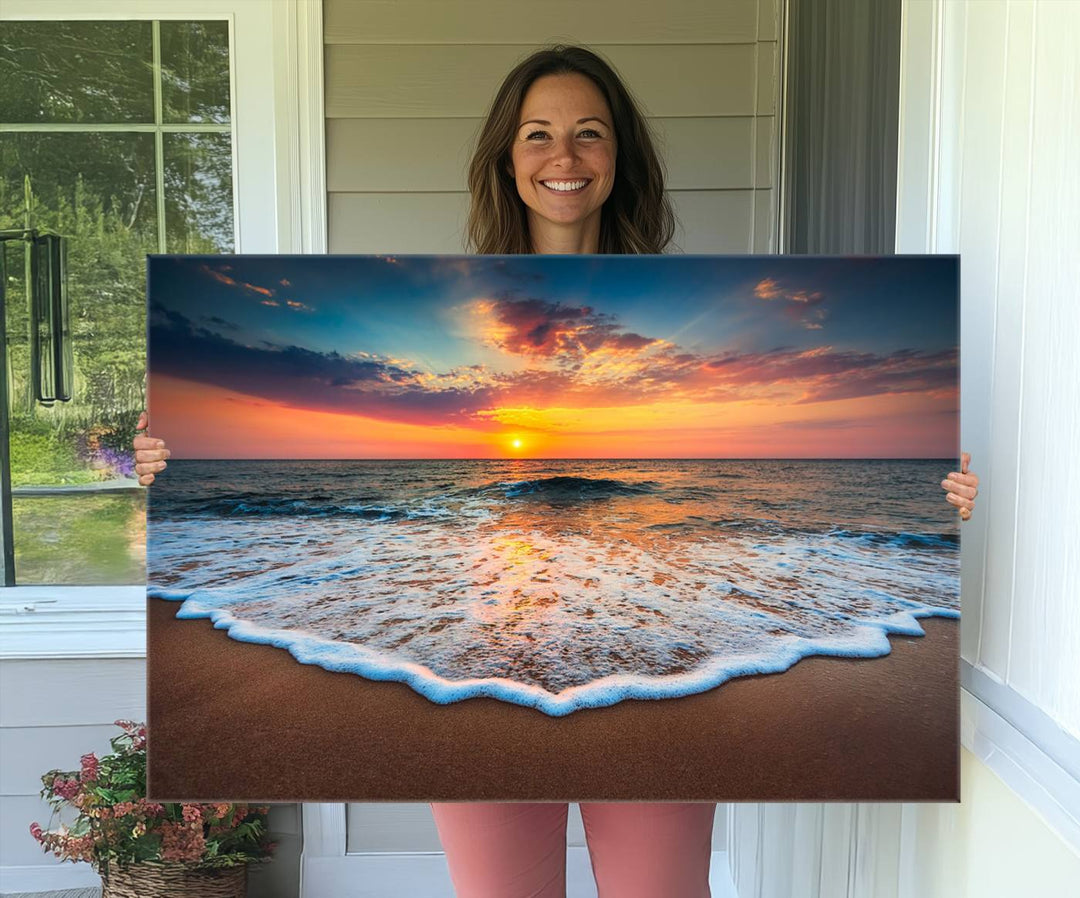 A Sunset with Calm Waves on the Beach Wall Art Canvas Print adorns the dining room.