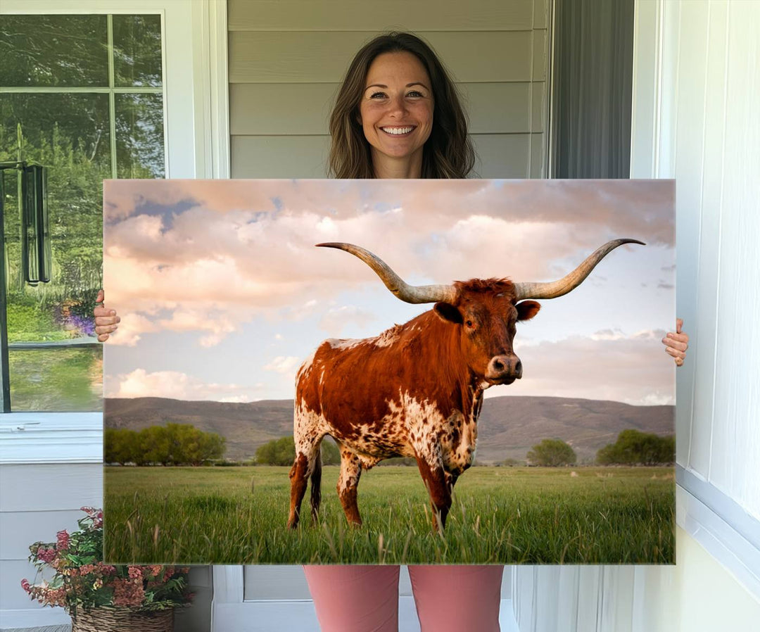 The Texas Cow Canvas Wall Art print captures a longhorn cow at sunset and is ready to hang.