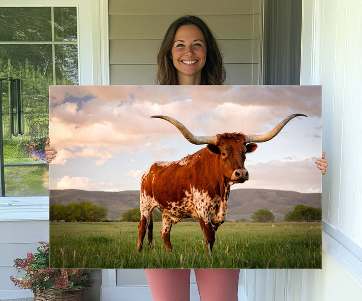 The Texas Cow Canvas Wall Art print captures a longhorn cow at sunset and is ready to hang.