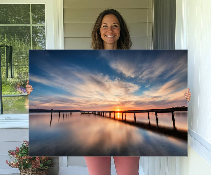 The Sunset Pier Canvas features a serene coastal landscape with vibrant hues under cloudy skies, ideal for modern decor.