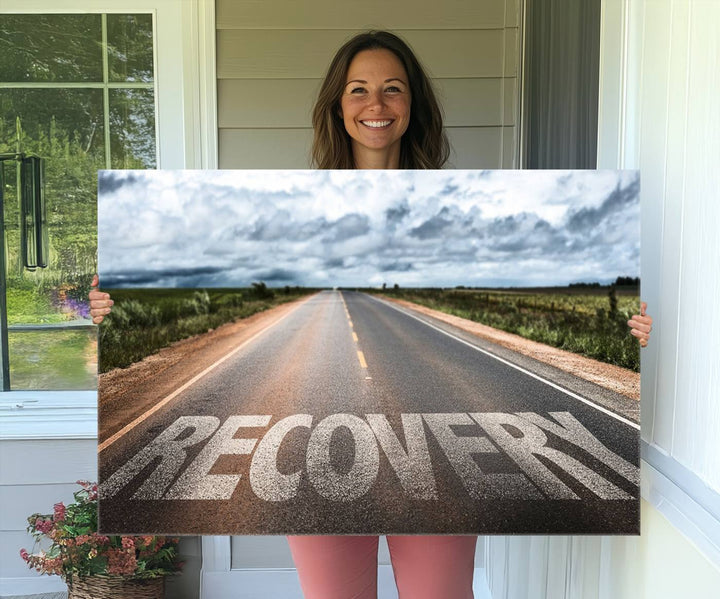 The Recovery Road Wall Art Canvas Print depicts a road under a cloudy horizon.