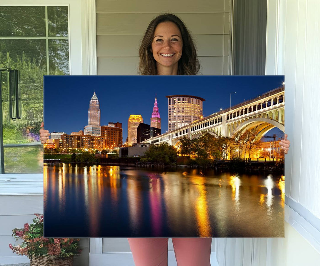 Cleveland Night Skyline Canvas: Cityscape with an illuminated bridge reflecting on calm water.